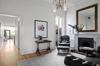 Inside the Robert Simeoni-designed Carlton North terrace with a floating bed and glass walls